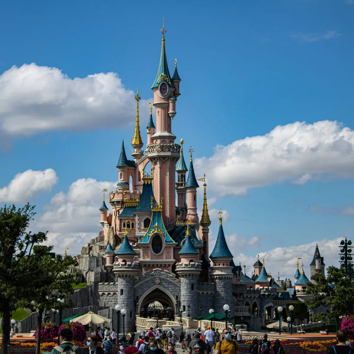 Aurora Castle, Sleeping Beauty in the center, with white clouds and a blue sky at Disneyland Paris.