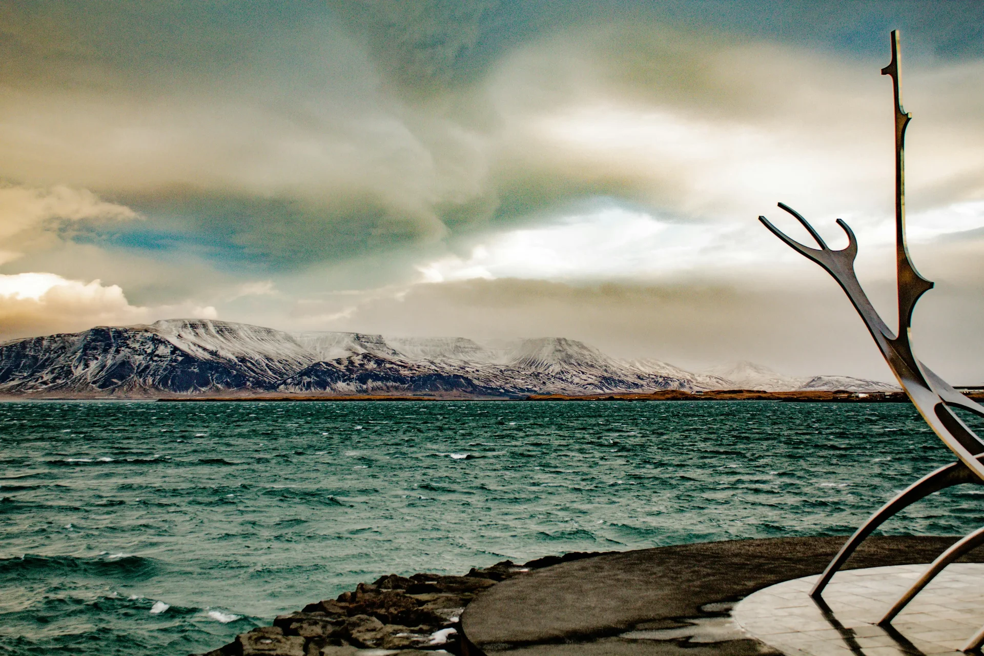 Reykjavik's landscape with snow-capped mountains and sea, a perfect European destination to explore in 2025.